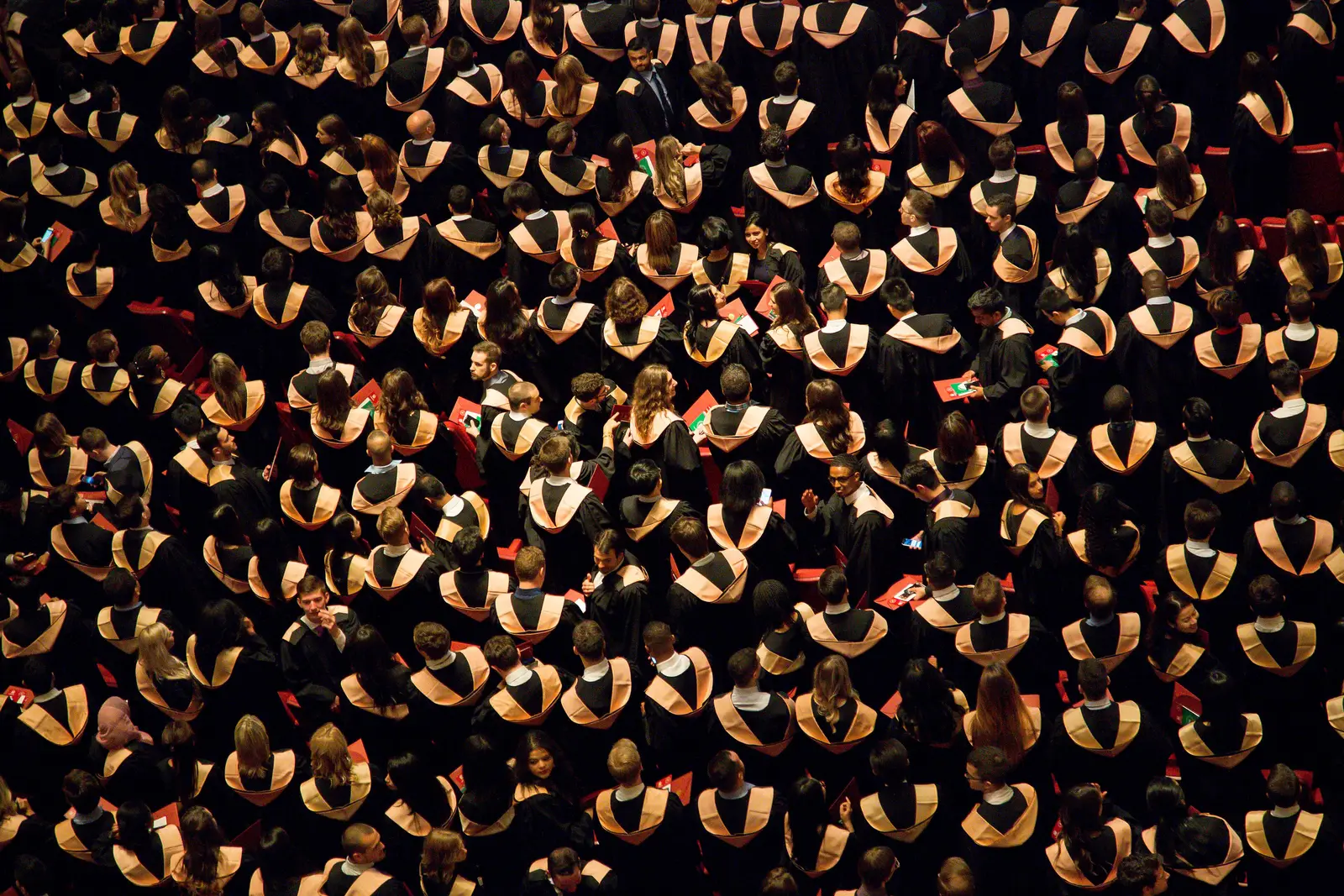 Aerial view of graduates in caps and gowns gathered at a university commencement ceremony